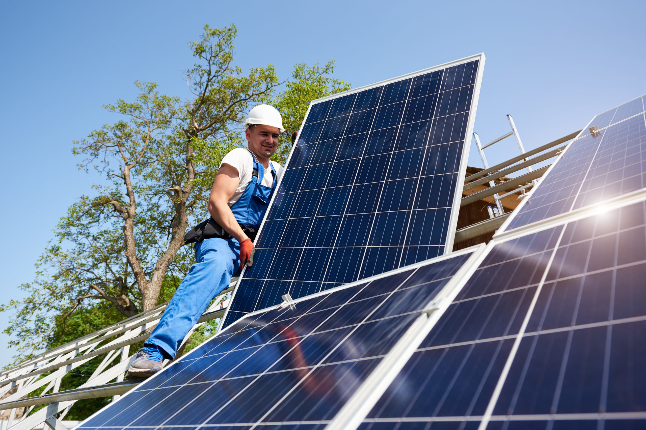 THE COMMUNITY INVESTMENT GUARANTEE POOL (CIGP) — man installing solar panels on roof