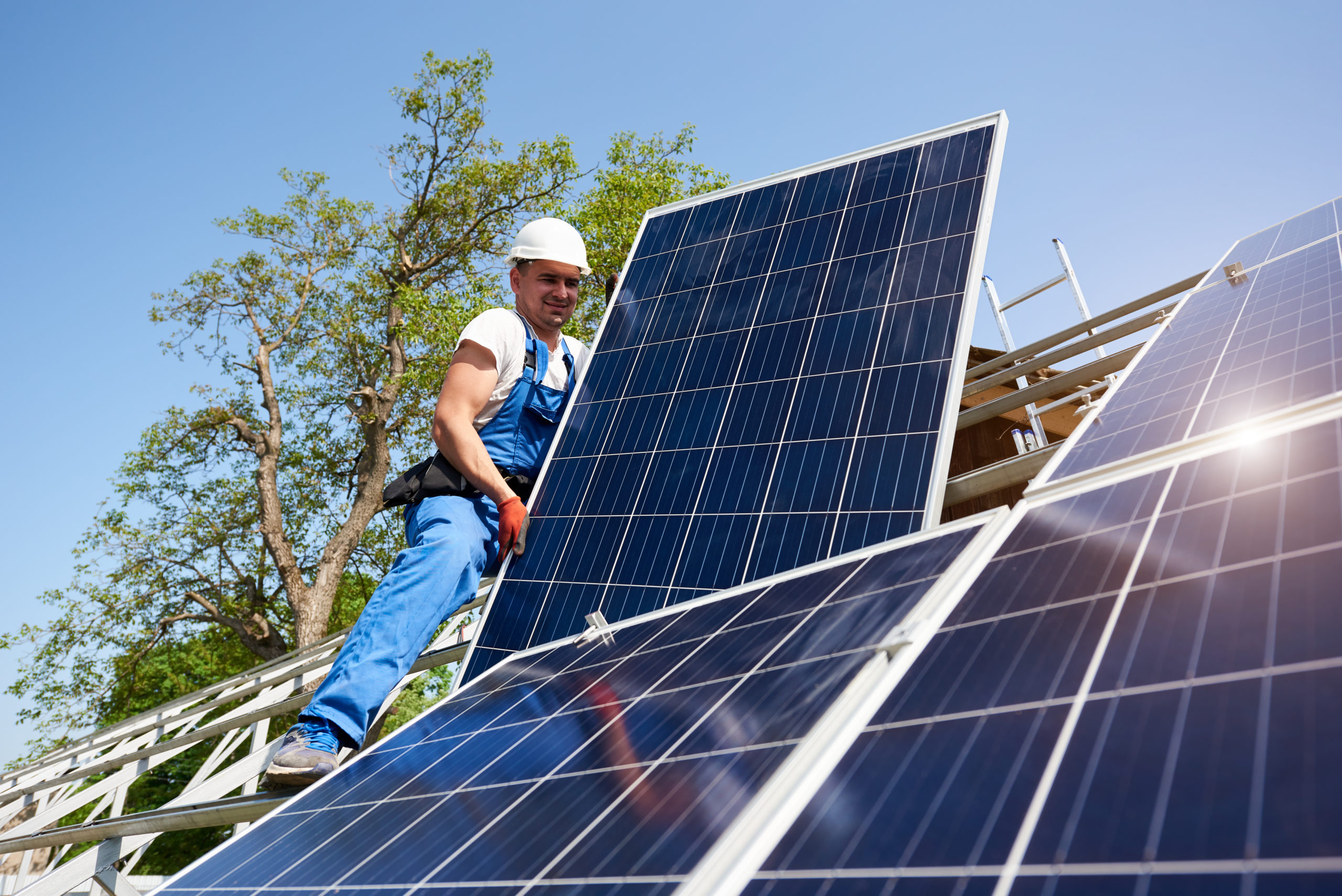 THE COMMUNITY INVESTMENT GUARANTEE POOL (CIGP) — man installing solar panels on roof