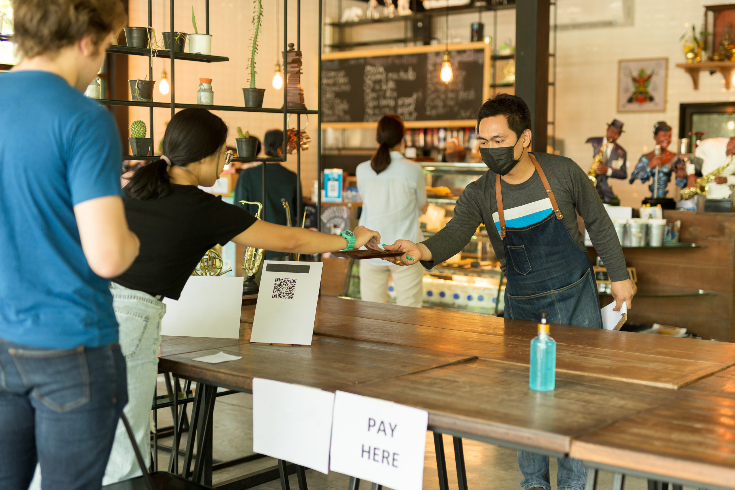 THE COMMUNITY INVESTMENT GUARANTEE POOL (CIGP) — store owner taking payment from customer